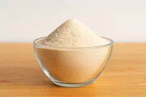 psyllium husk powder in a glass bowl placed on a table.